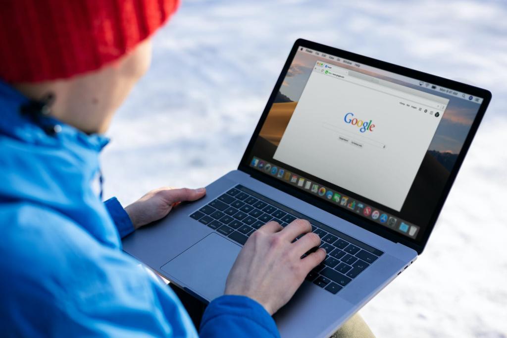 person in blue jacket using macbook pro